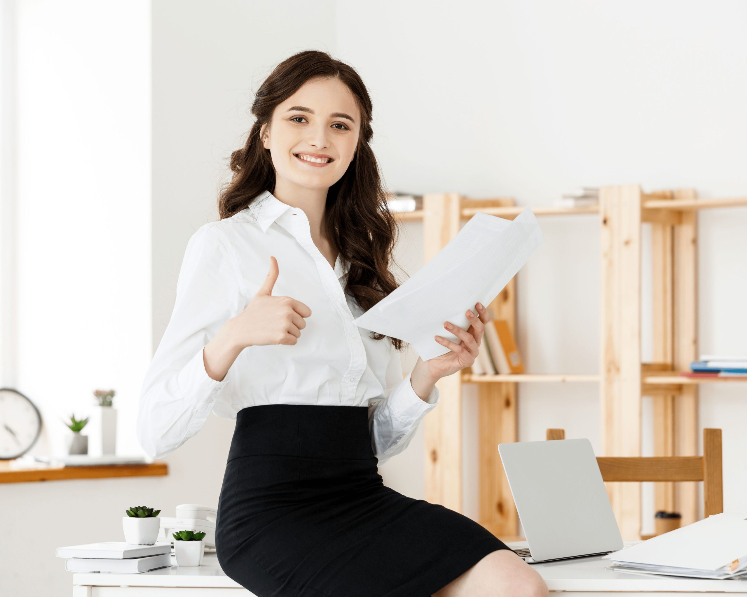 10 8happy young business woman secretary holding document modern office scaled